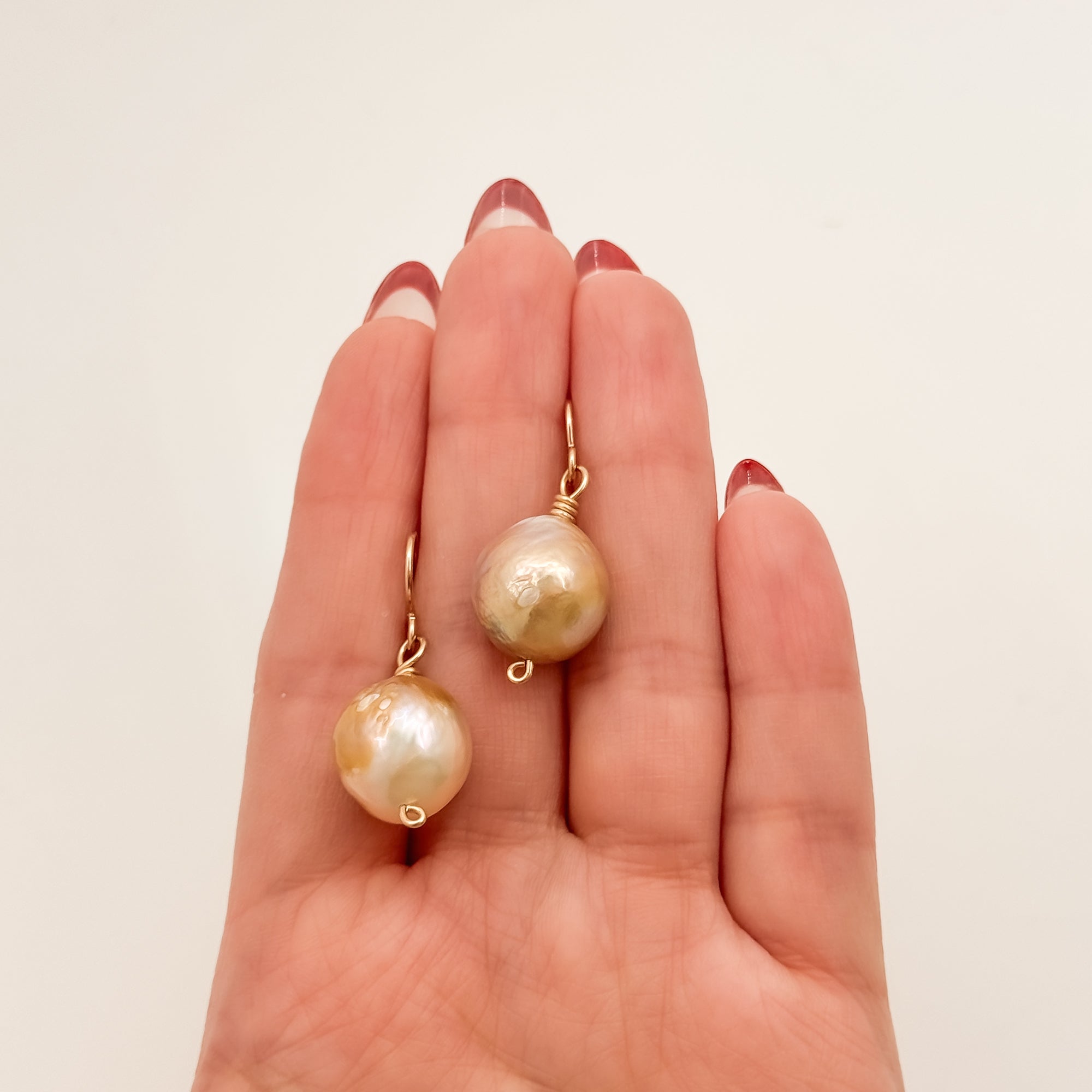Single large Champagne Baroque pearl earrings