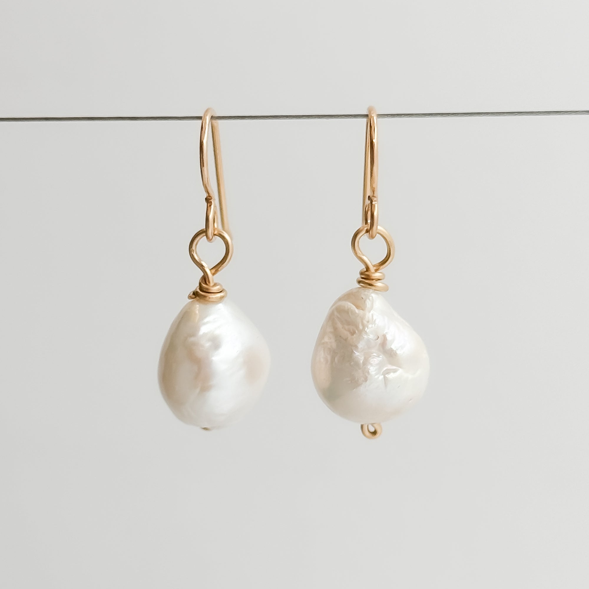Single Med white Baroque pearl earrings