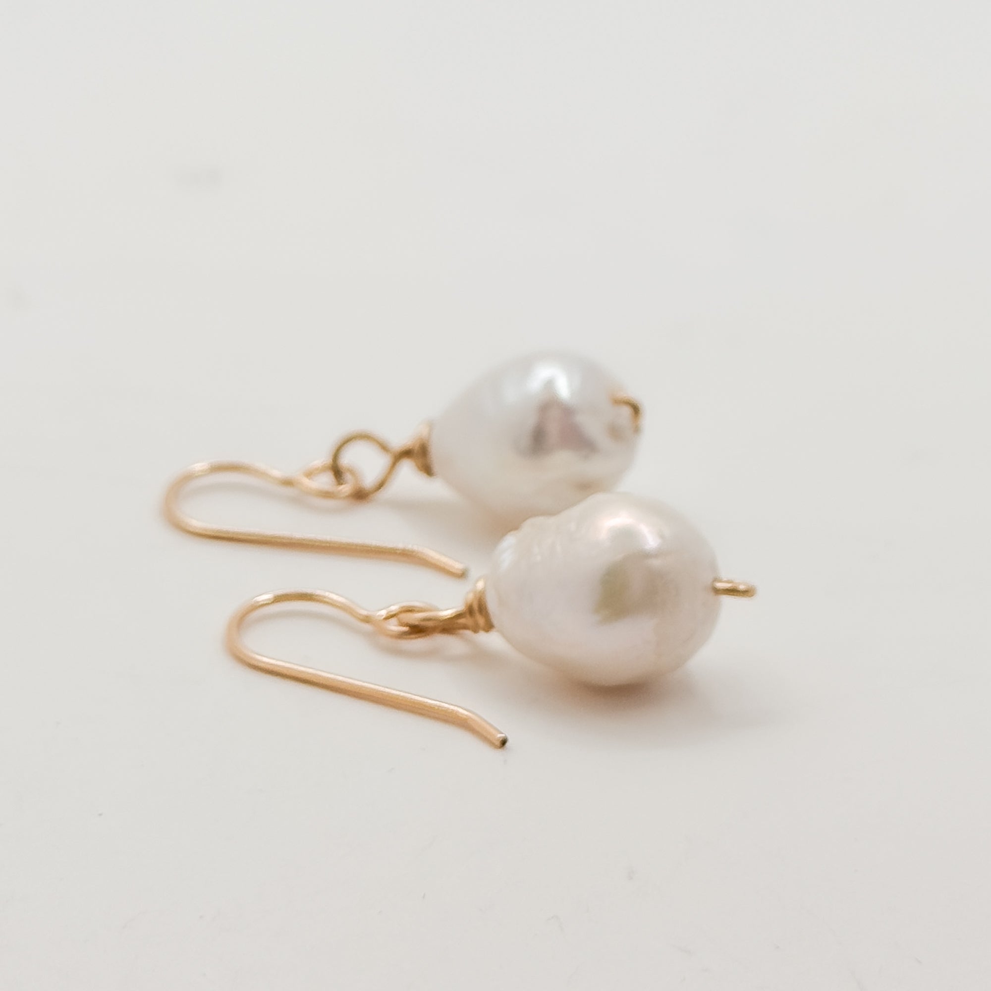 Single Med white Baroque pearl earrings