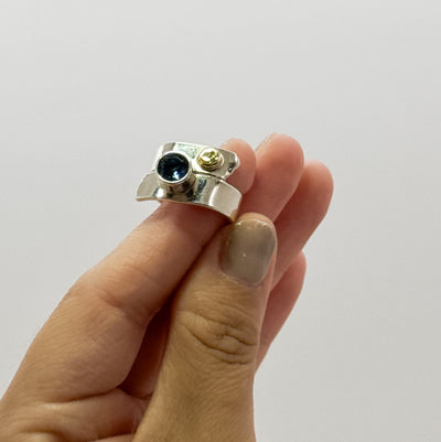 Overlap ring with faceted blue topaz