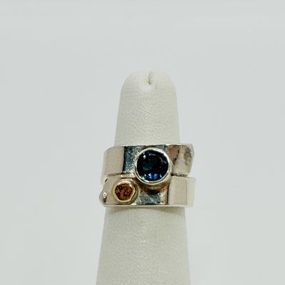 Overlap ring with faceted blue topaz