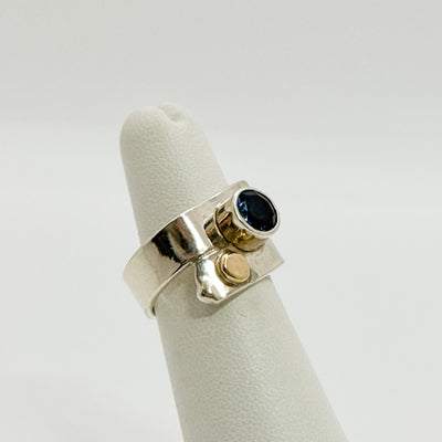 Overlap ring with faceted blue topaz