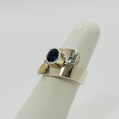 Overlap ring with faceted blue topaz