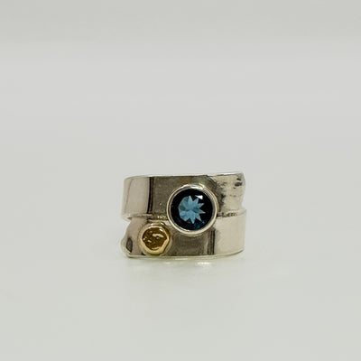 Overlap ring with faceted blue topaz
