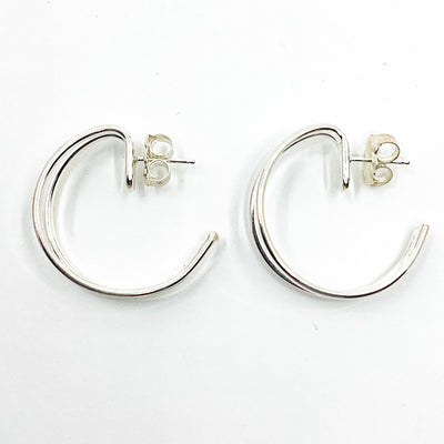 over top view of Sterling Looped End Earrings by Judie Raiford