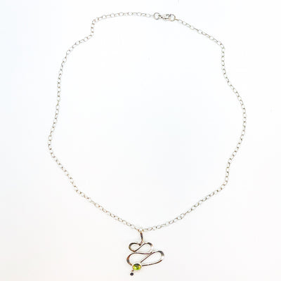 flat lay view of sterling silver Touch of Romance Necklace with Peridot by Judie Raiford
