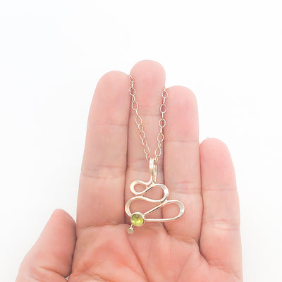 sterling silver Touch of Romance Necklace with Peridot by Judie Raiford held in hand