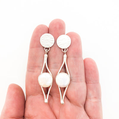 Sterling silver Split Earrings with White Coin Pearl by Judie Raiford held in hand