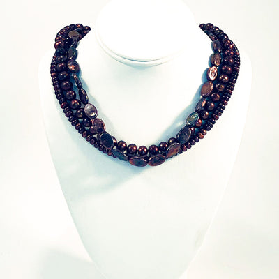 Triple Strand Copper Coin and Round Pearl Necklace by Judie Raiford on white jewelry display bust