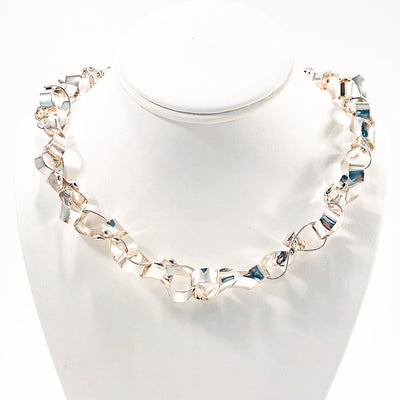 Sterling Davine Necklace by Judie Raiford on white display bust