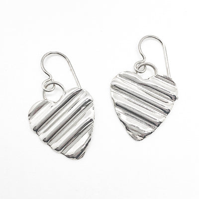 flat lay view of Small Sterling Silver Corrugated Heart Earrings by Judie Raiford