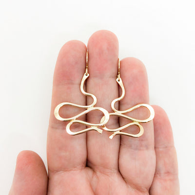 14k Gold Filled Touch of Romance Earrings by Judie Raiford held in hand