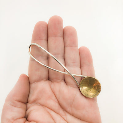 Sterling Salt Spoon with Coin by Judie Raiford held in hand