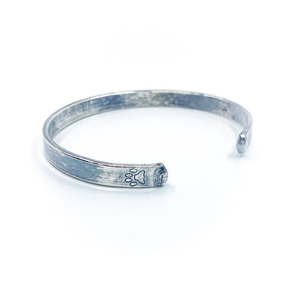 side angle back view of Oxidized Sterling Flat Band Cuff with Paw Print by Judie Raiford