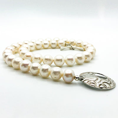 side angle view of Sterling Cupcake Necklace with White Baroque Pearls by Judie Raiford