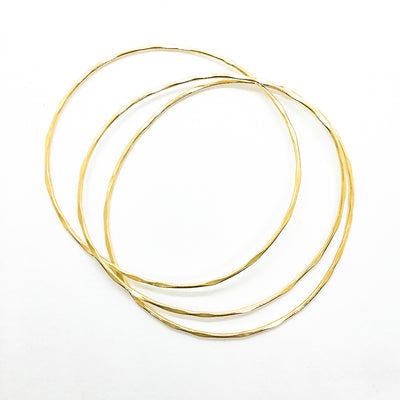 over top view of 14k Gold Filled Skinny 3-Piece Bangle Set by Judie Raiford