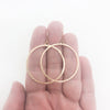 14k Gold Filled Mom's Hammer Flat Orbit Earrings by Judie Raiford held in hand