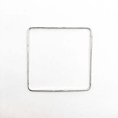over top view of Sterling Hammered Square Bangle by Judie Raiford