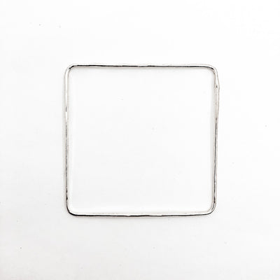 over top view of Sterling Hammered Square Bangle by Judie Raiford