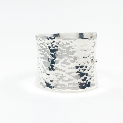 left side view of Sterling 1.5" Ball Pein Anticlastic Cuff by Judie Raiford
