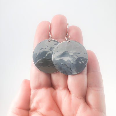 Sterling Lynne Disc Earrings by Judie Raiford held in hand