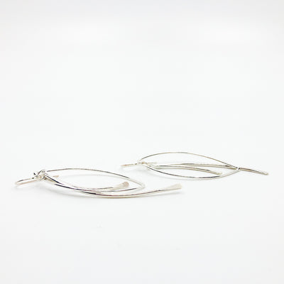 side angle view of Sterling Large Paddle Bag Earrings by Judie Raiford