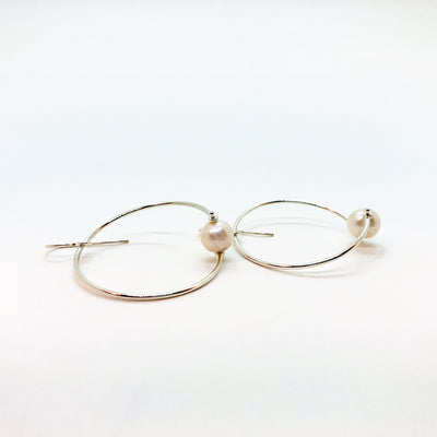 side angle view of Sterling Twisted Hoop Pearl Earrings by Judie Raiford