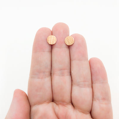 14k Gold Filled Gauze Textured Circle Stud Earrings by Judie Raiford held in hand