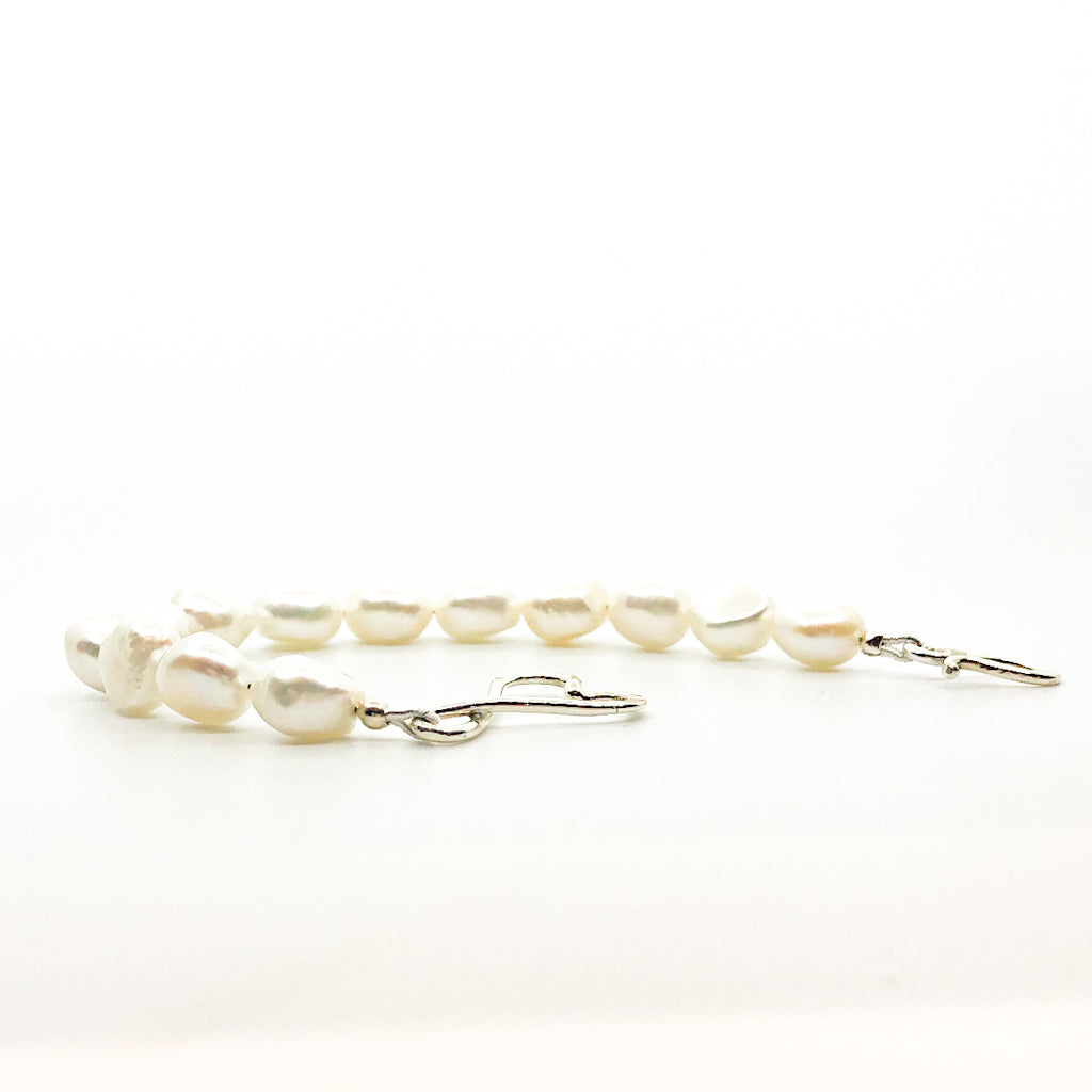 side angle view of Sterling White Small Baroque Pearl Bracelet with Heart Clasp by Judie Raiford