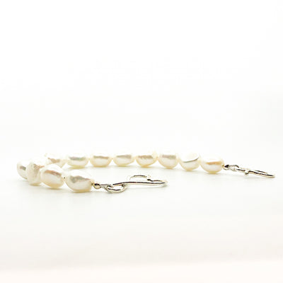 side angle view of Sterling White Small Baroque Pearl Bracelet with Heart Clasp by Judie Raiford