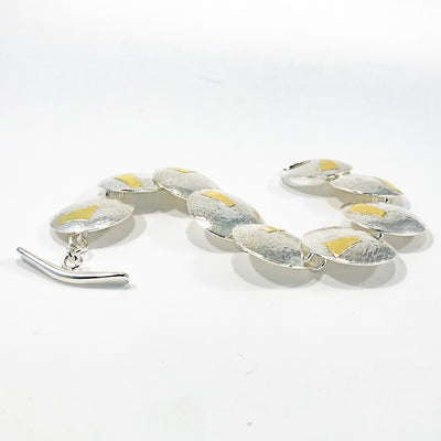 side angle view of Sterling and 24K Bark Bracelet by Judie Raiford