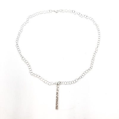 flat lay view of sterling silver Large Hammered Bar Necklace by Judie Raiford