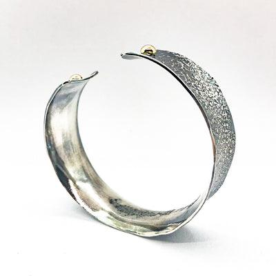 side angle view of 3/4" Mom's Hammer Oxidized Sterling Anticlastic Cuff with 14k Gold Balls by Judie Raiford