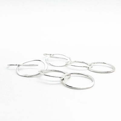 side angle view of sterling silver Hammered Triple Circle Earrings by Judie Raiford