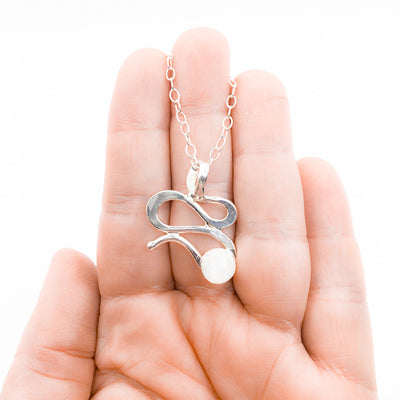 Sterling Touch of Romance Necklace with Moonstone by Judie Raiford held in hand