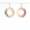 14k Gold Filled Ball Pein Hammered Donut Earrings by Judie Raiford hanging on wire