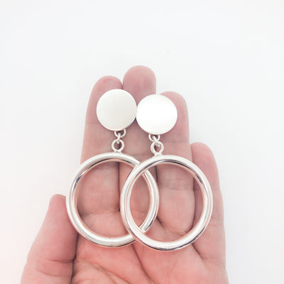 sterling silver Marilyn Monroe Earrings by Judie Raiford held in hand