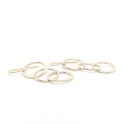 side angle lay of 14k Gold Filled Hammered Triple Circle Earrings by Judie Raiford