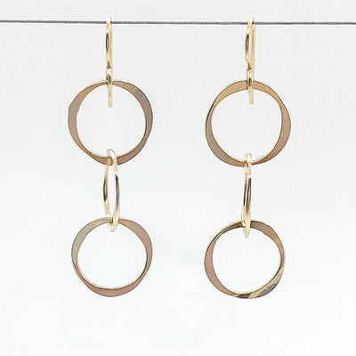14k Gold Filled Hammered Triple Circle Earrings by Judie Raiford hanging on a wire