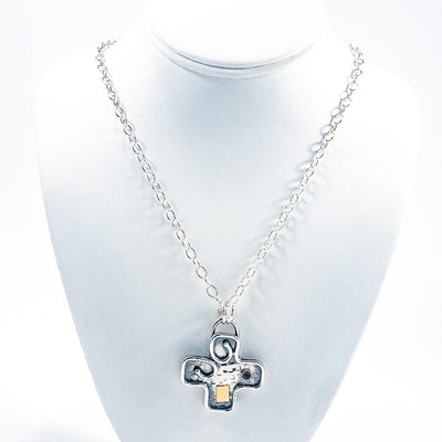 Big Honker Cross Necklace by Judie Raiford on white jewelry display bust