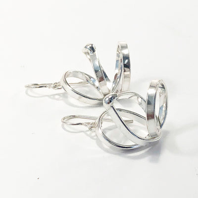 side view of Sterling Curly Girl Earrings by Judie Raiford