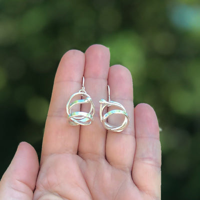 held in hand view of Sterling Curly Girl Earrings by Judie Raiford