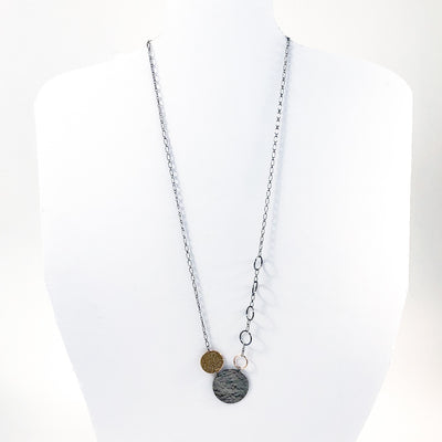 Oxidized Sterling and 14k Gold Fill Hammered Circles Necklace by Judie Raiford displayed on white mannequin bust