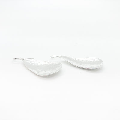 side angle view of sterling silver Sinclastic Pear Shaped Earrings by Judie Raiford