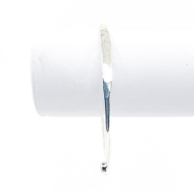 Sterling Naught Bangle with Opal by Judie Raiford hanging on white bracelet display stand