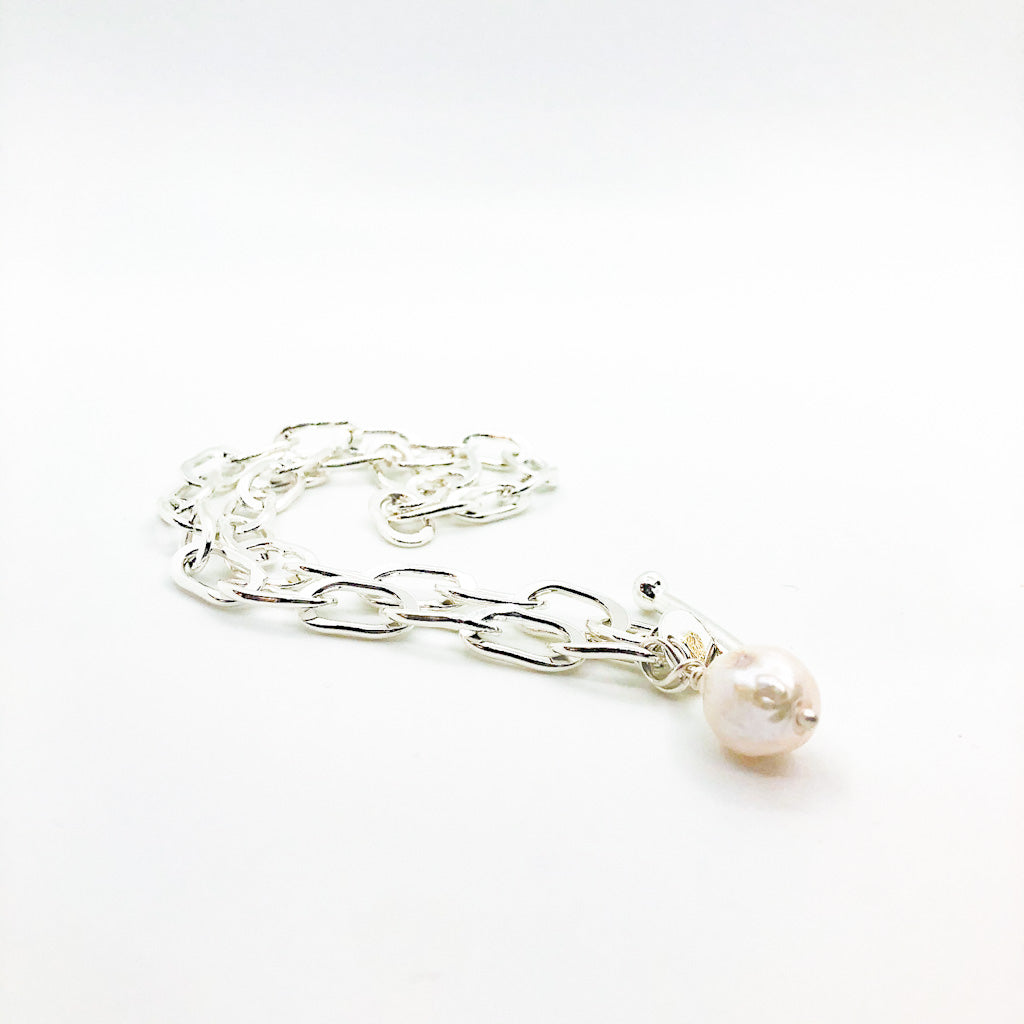 side angle view of Junior Tow Truck Necklace with 14k Dangle and Large Baroque Pearl by Judie Raiford