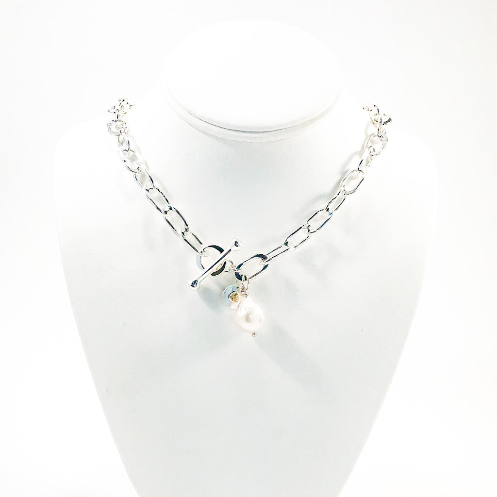 Junior Tow Truck Necklace with 14k Dangle and Large Baroque Pearl by Judie Raiford on white display mannequin