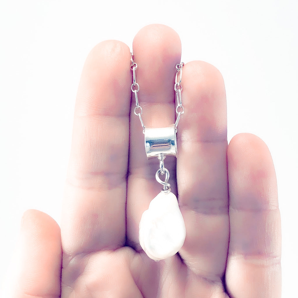 White Baroque Pearl on Sterling Long Short Chain by Judie Raiford held in hand