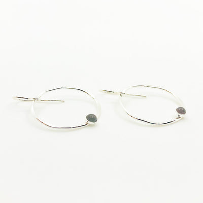 side angle view of Sterling Baby Orbit Earrings with Garnet by Judie Raiford