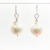 Large White Baroque Pearl Earrings by Judie Raiford hanging on wire